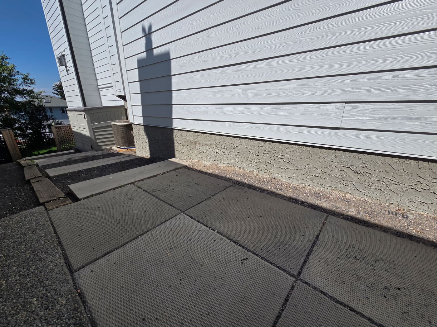 The same Calgary foundation wall after parging rejuvenation, finished in one uniform tone